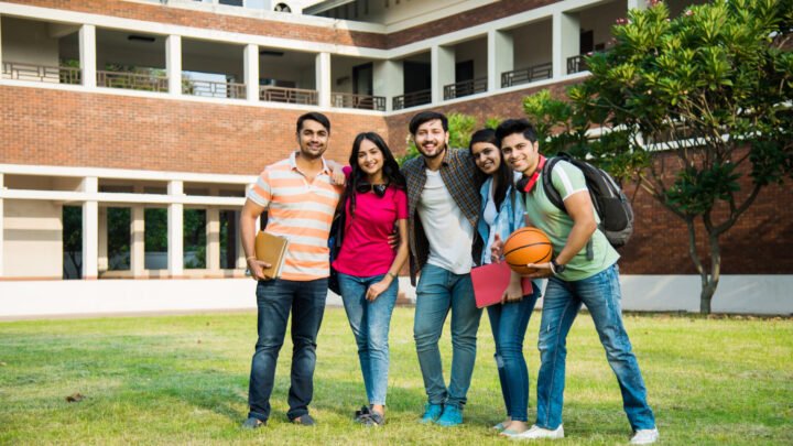 Group of PU students with books standing outside a residential college campus in Mangalore